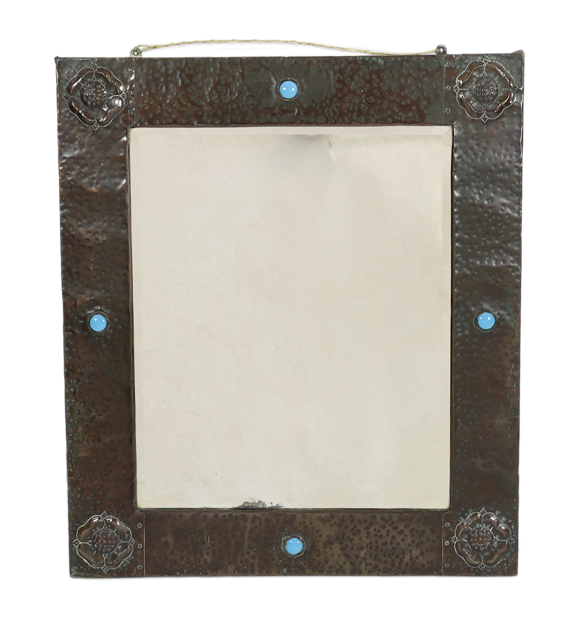 A Liberty & Co. Arts & Crafts planished copper wall mirror